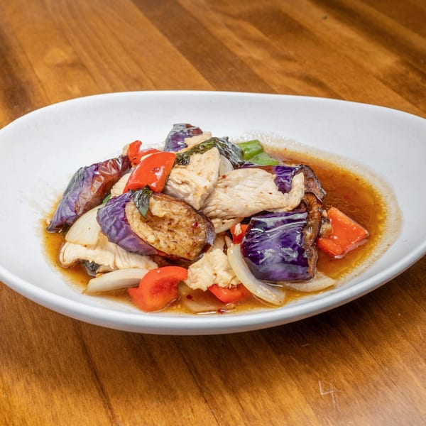 Wild Tiger Thai's stir-fried chicken with eggplant, bell peppers, and onions in a savory sauce.