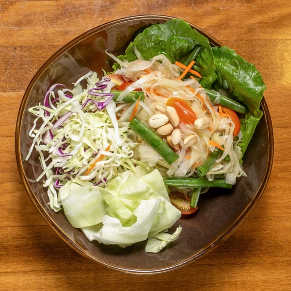 Wild Tiger Thai's papaya salad with shredded cabbage, green beans, tomatoes, and peanuts.